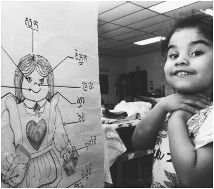 Angelina Melendez is learning the parts of the body from a chart written in the Cambodian language of Khmer. Angelina attends the Demonstration School, which was developed to meet the educational needs of students who speak English as a second language.