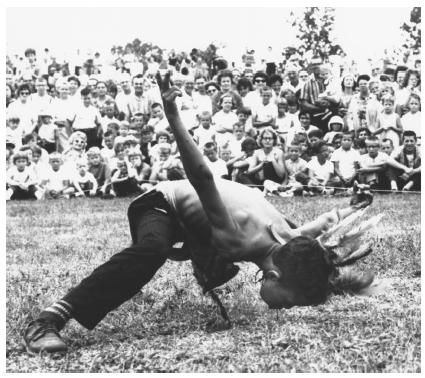 Marion (Wild Horse) McGhee performs the fluff dance, attempting to pick up a feather with his teeth without his knees, hands or forehead touching the ground.