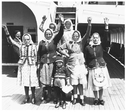 These Czech emigrants are waving from the S.S. President Harding, which landed in New York City on May 25, 1935. They later joined relatives in Ohio.