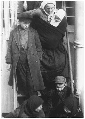 In this 1921 photograph, a Dutch woman and her children prepare to depart from the S.S. Vedic in New York City.