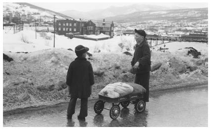 These children of French Canadian papermill workers have an enjoyable day playing on the hill looking down on the town.