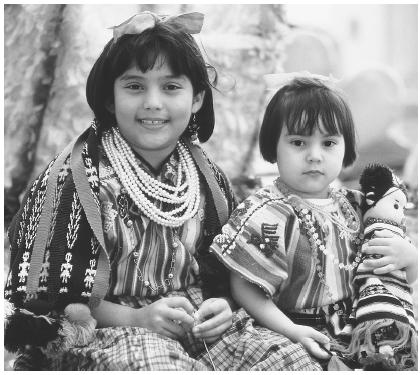 These two girls are wearing traditionally handwoven Guatemalan dresses as they particate in the Central America Ethnic Pride Parade in Chicago.