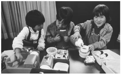 These Japanese American children are eating obento lunches.