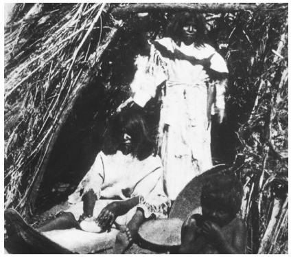 Many Native groups retain their ancient forms of completing tasks, such as this Paiute woman grinding seeds.
