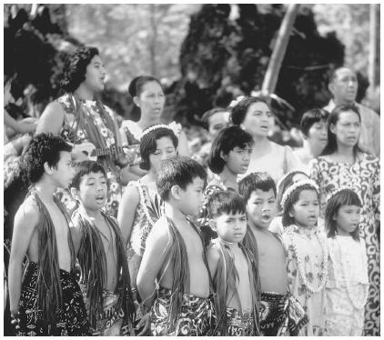 These Tongan American school children are  singing at a luau celebrating a new road being built in Milolii, Hawaii.